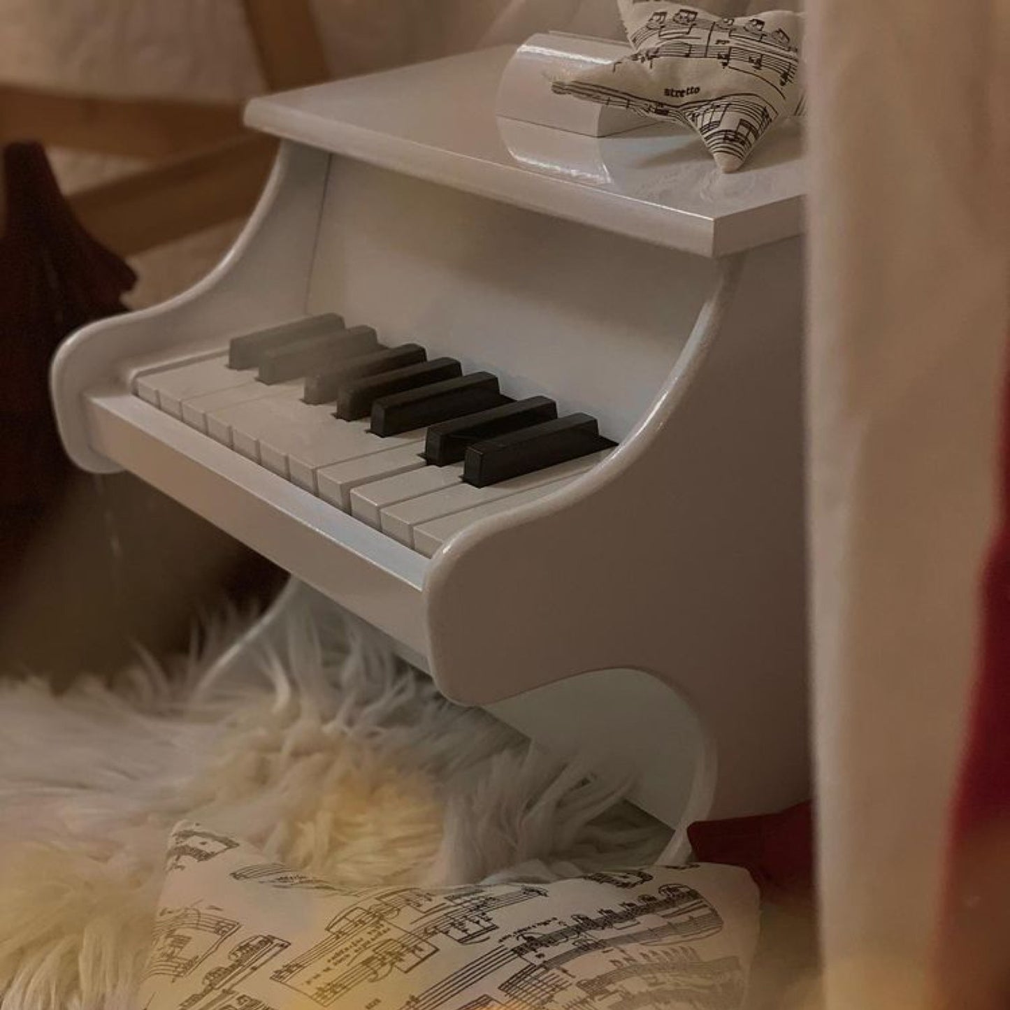 White piano with scores