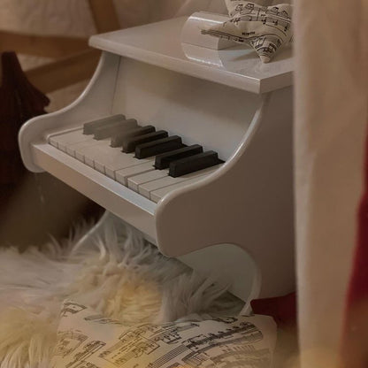 White piano with scores