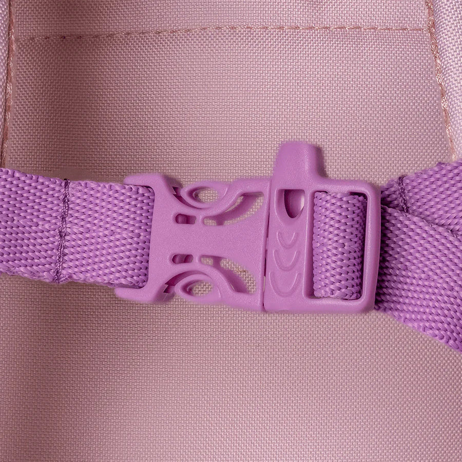 Close-up of a purple buckle on a pink fabric background