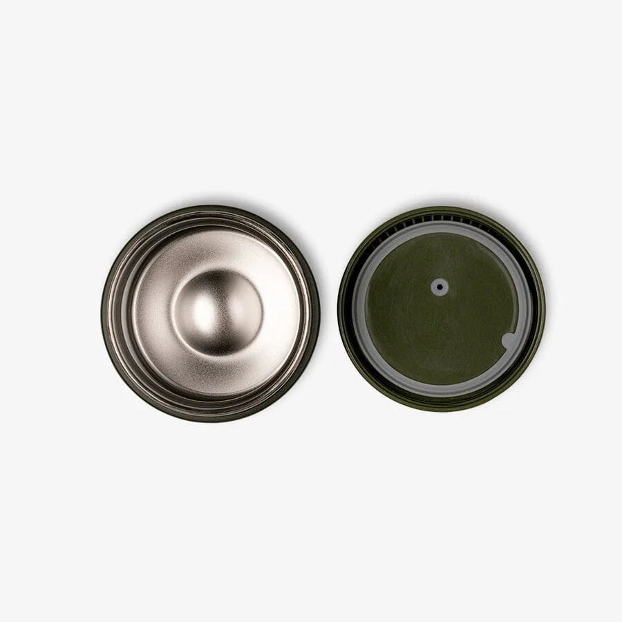 Two metallic objects, one silver and one green, on a white background