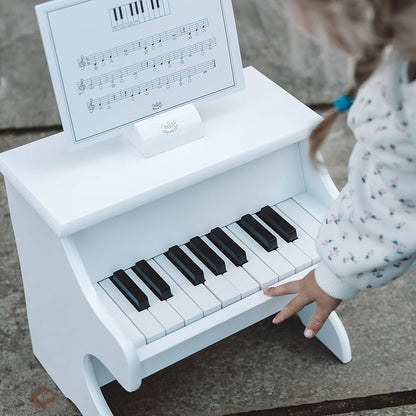 White piano with scores