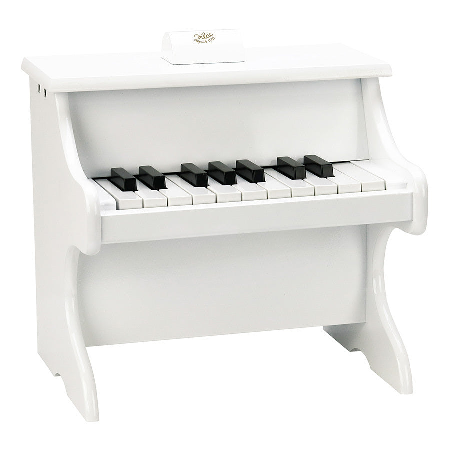 White piano with scores