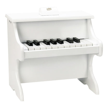 White piano with scores